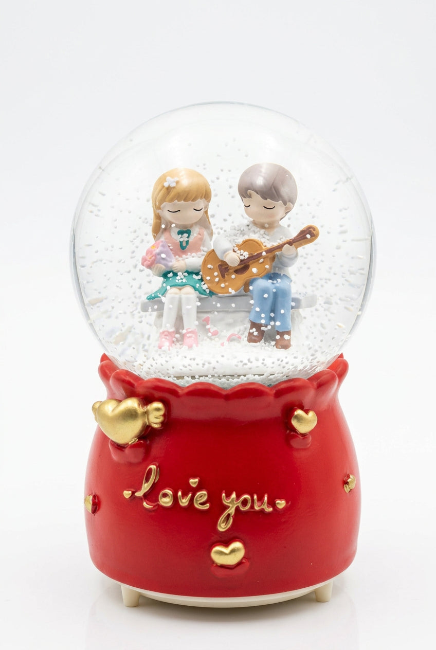 Romantic couple musical snow globe